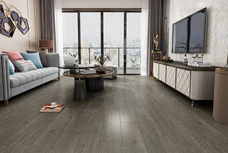 An Empty Living Room With A Wooden Floor And White Walls — Mid Coast Flooring & Blinds In Taree, NSW