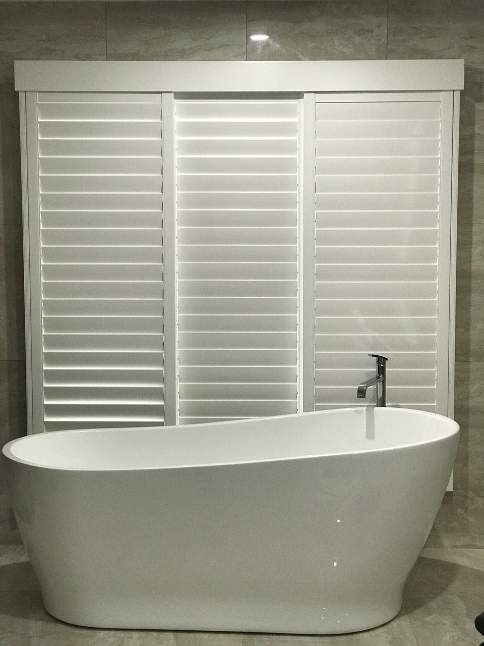 A Bedroom With a Bed , Dresser , and Shutters on the Windows — Mid Coast Flooring & Blinds In Taree, NSW