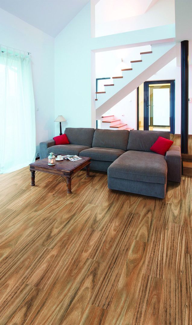 A Living Room With A Couch And A Coffee Table On A Wooden Floor — Mid Coast Flooring & Blinds In Taree, NSW