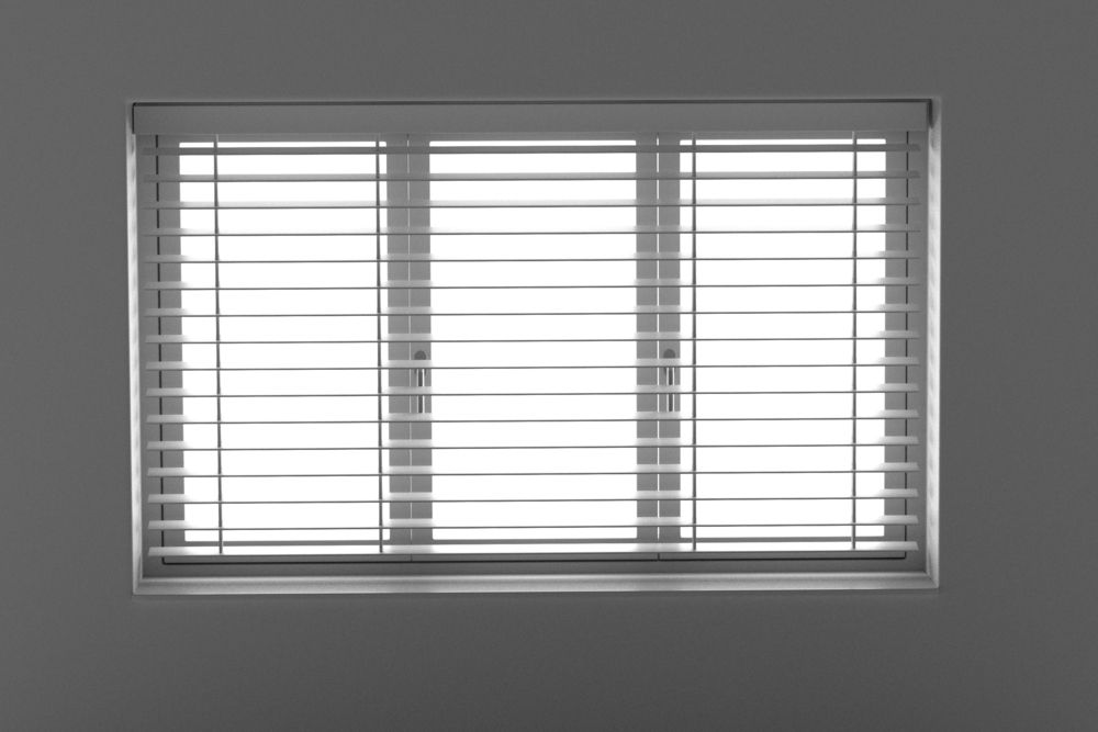 A Black And White Photo Of A Window With Blinds On It — Mid Coast Flooring & Blinds In Taree, NSW
