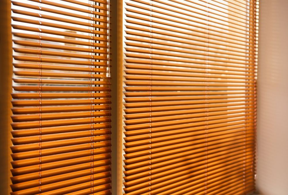 A Close Up Of A Window With Wooden Blinds On It — Mid Coast Flooring & Blinds In Taree, NSW