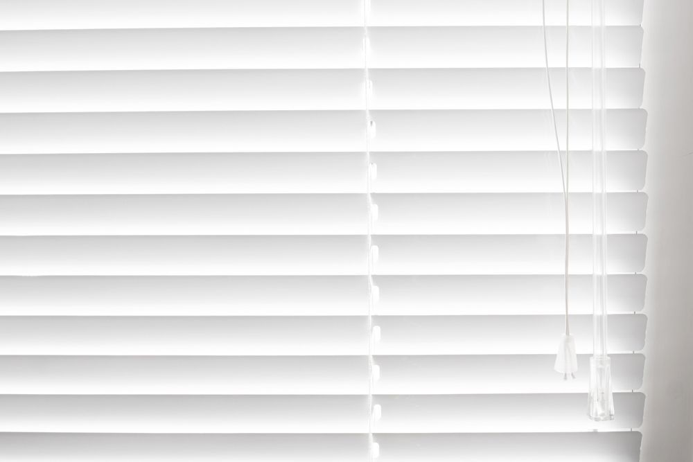 A Close Up Of A White Blind On A Window — Mid Coast Flooring & Blinds In Taree, NSW