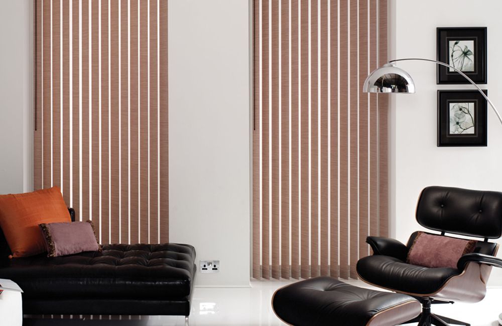 A Living Room With Vertical Blinds And A Black Chair — Mid Coast Flooring & Blinds In Old Bar, NSW