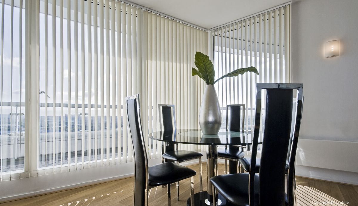 A Room With A Lot Of Vertical Blinds On The Windows — Mid Coast Flooring & Blinds In Harrington, NSW