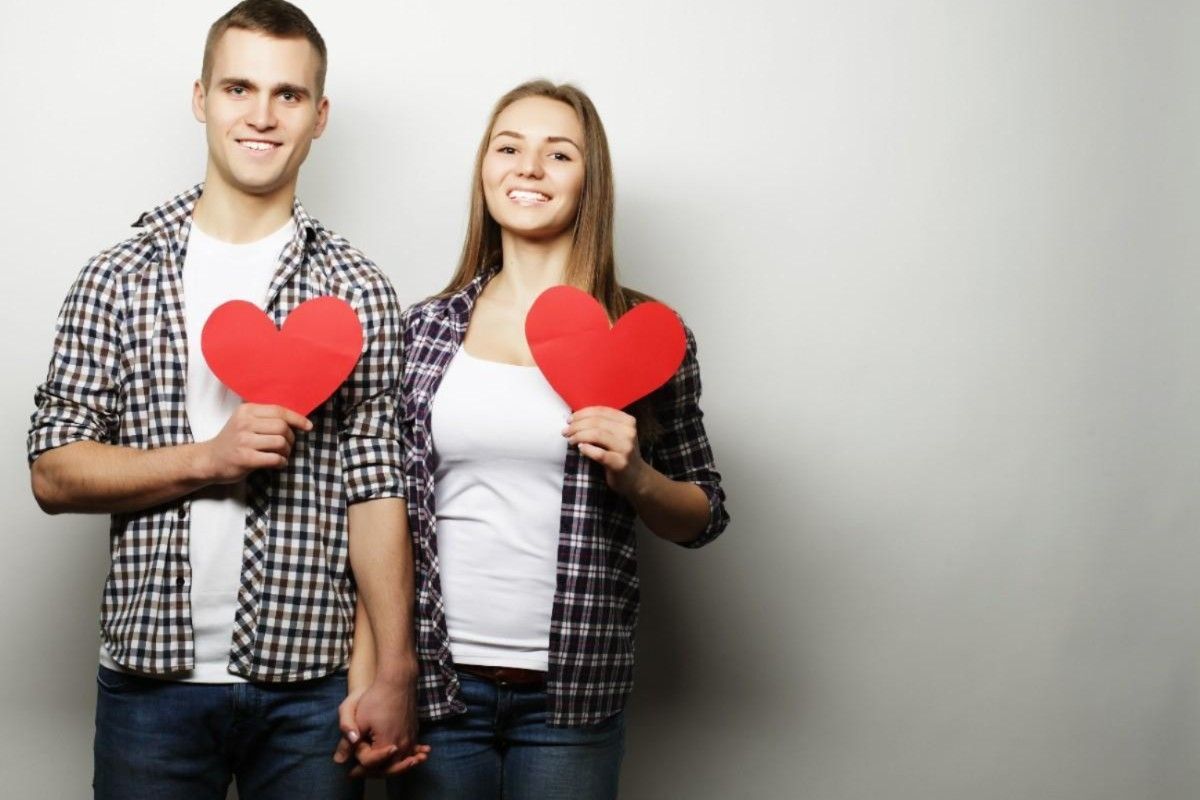 couple holding hands with heart symbol representing relationship commitment
