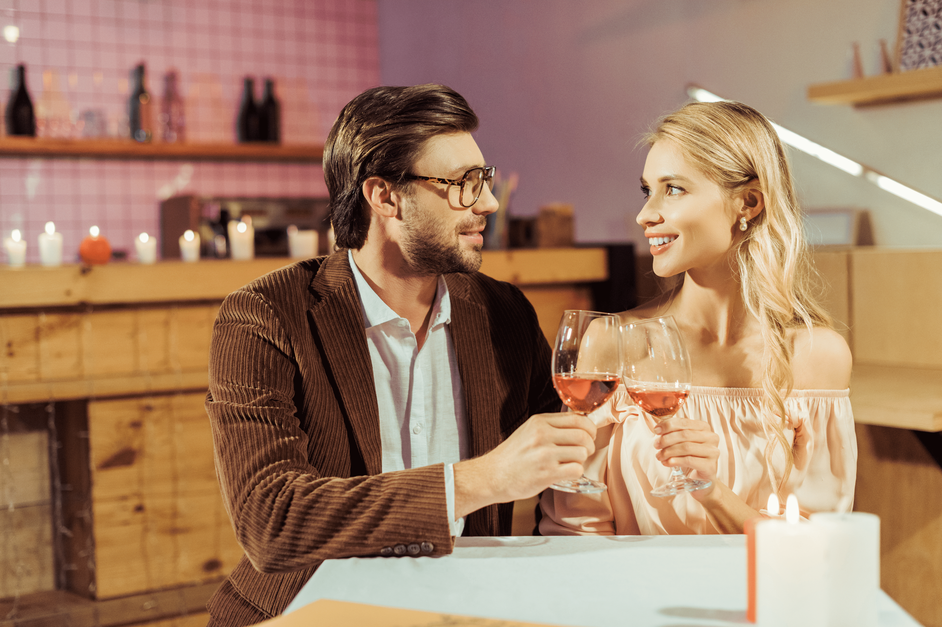 couples sitting holding the glasses of wine