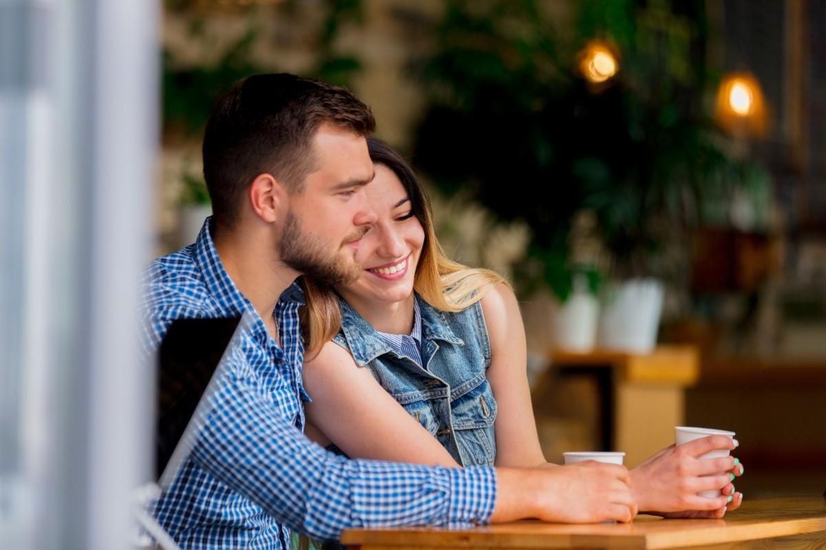 Couple hugging during coffee date showing transition from casual dating to serious relationship commitment