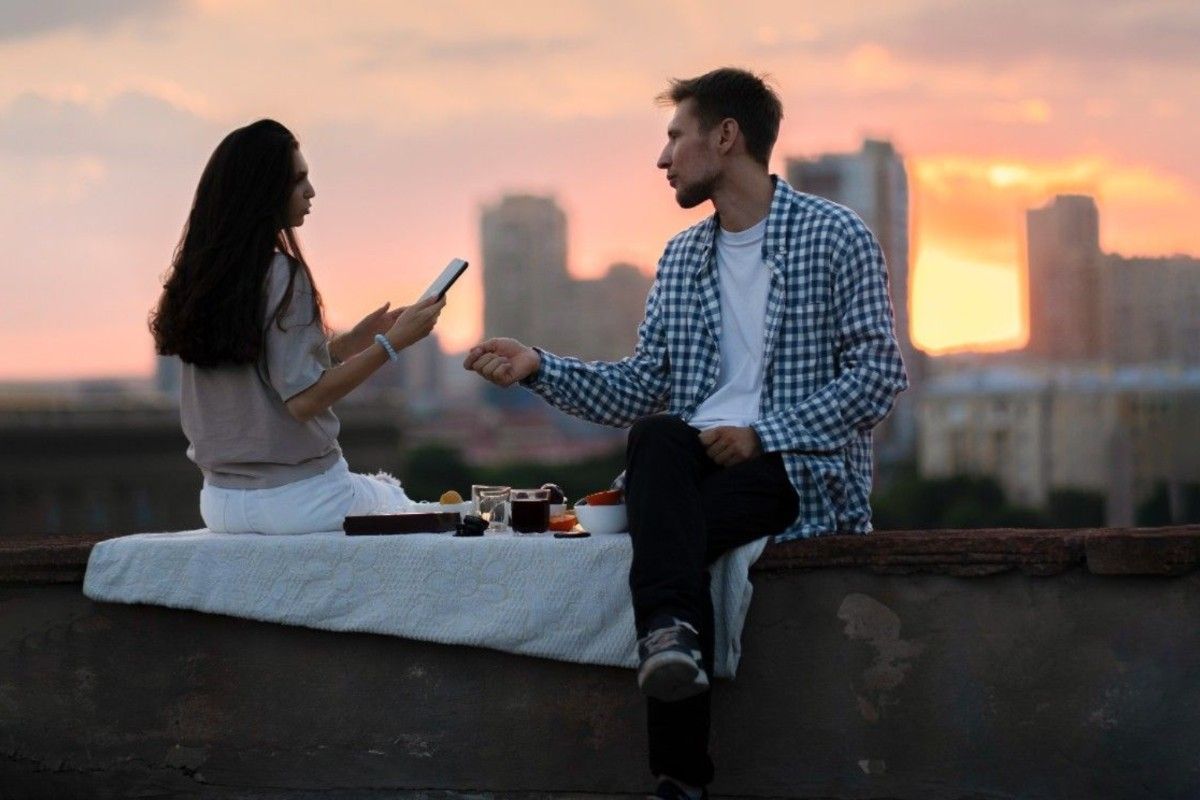 couple enjoying romantic rooftop picnic during early stages of dating