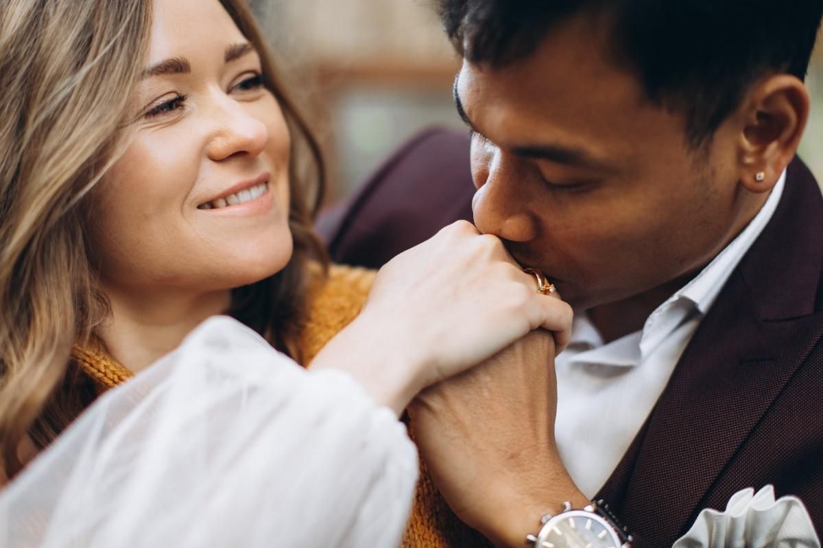 man kissing woman’s hand on date showing connection through professional matchmaking