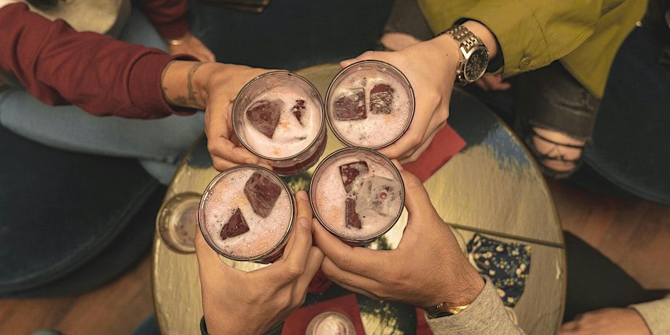 Group of friends clinking glasses at a social matchmaking event.