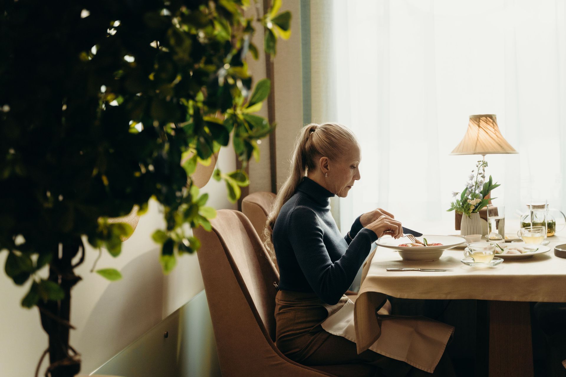 elegant woman 50s restaurant alone confident