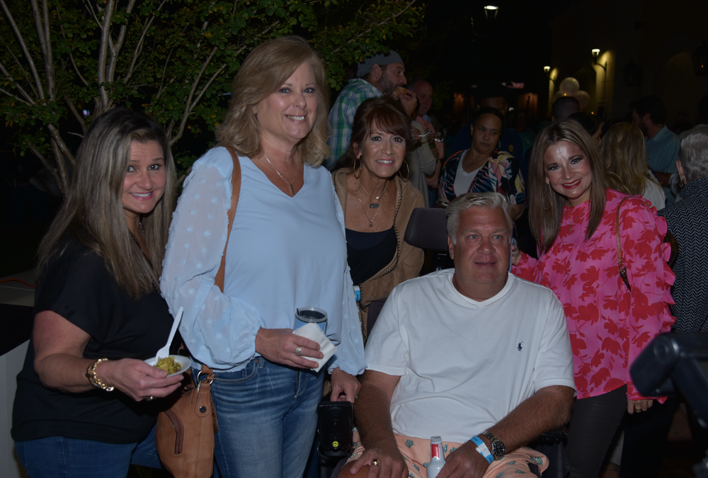 A group of people are posing for a picture at a party.