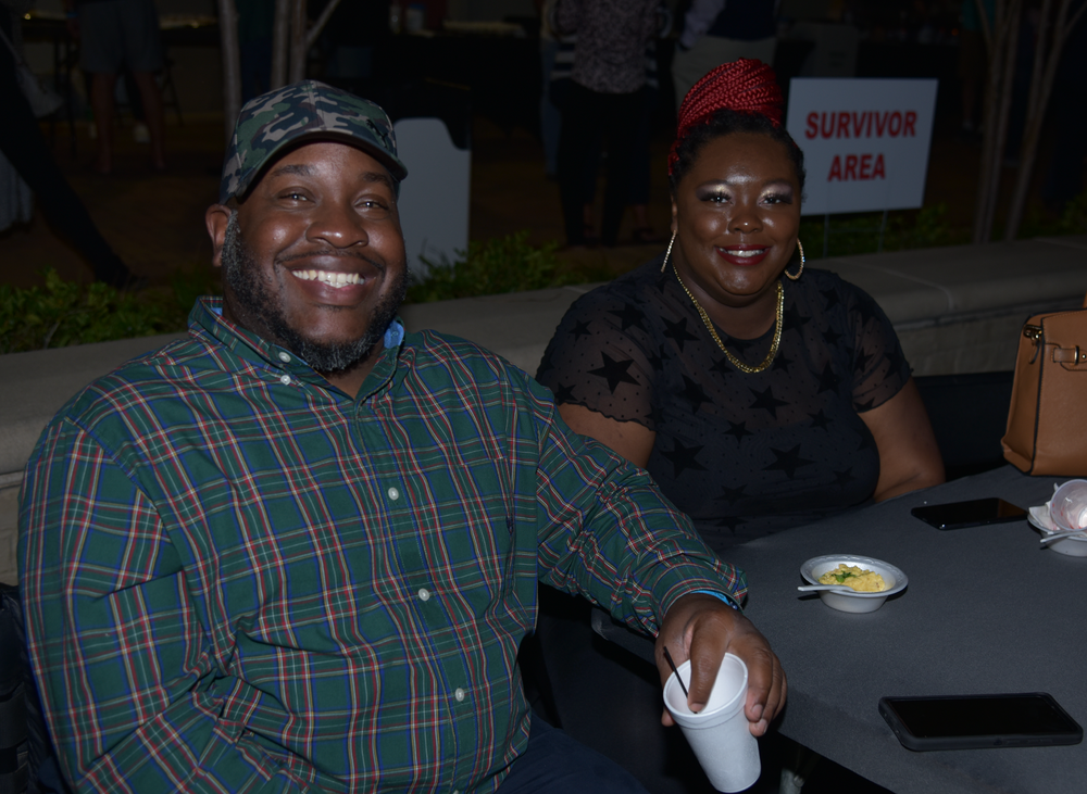 A man and a woman are sitting at a table and smiling.