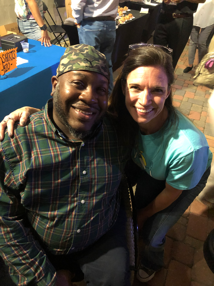 A man and a woman are posing for a picture at a party.
