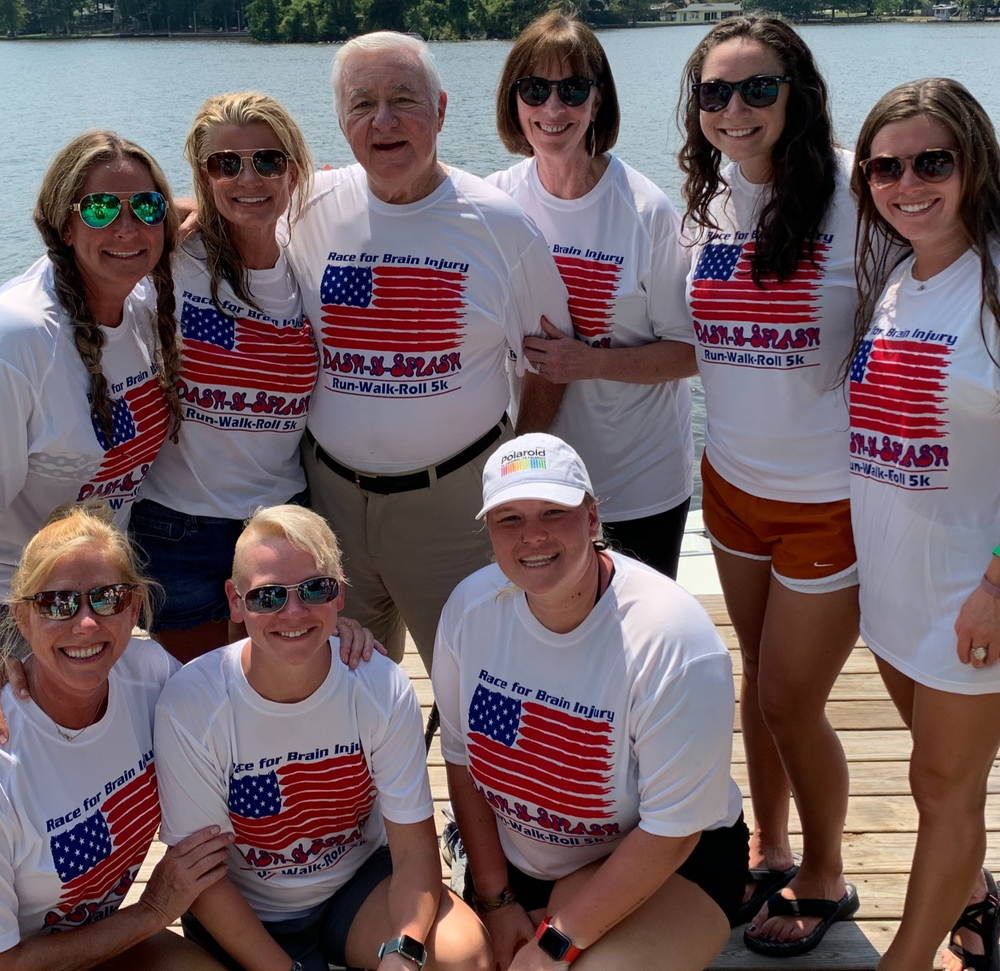 A group of people posing for a picture wearing american flag shirts