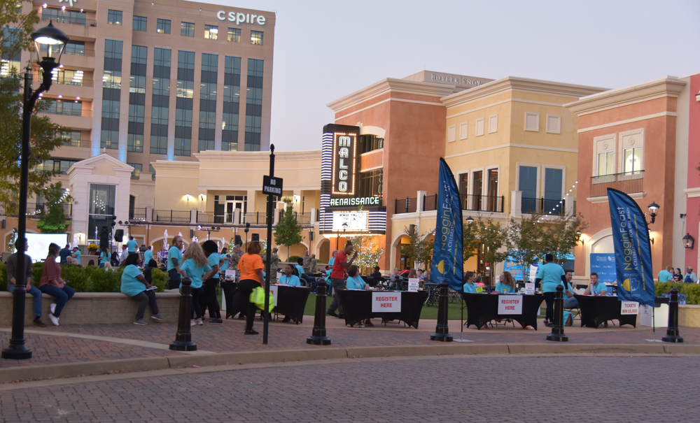 A group of people are gathered in front of a building that says esprit