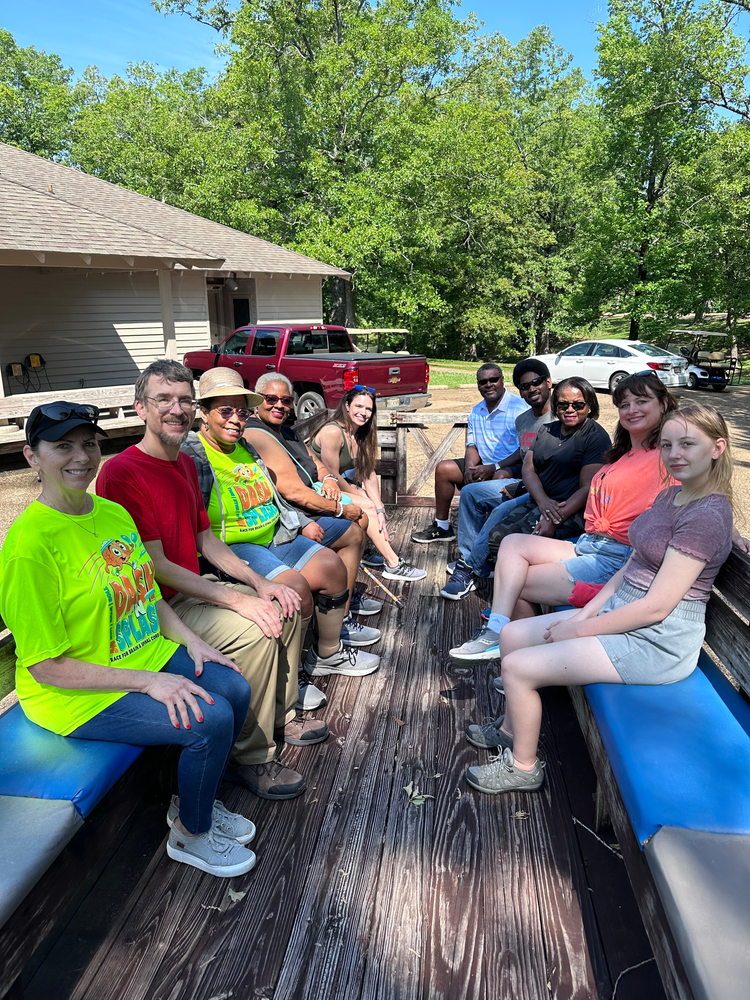 A group of people are sitting on the back of a train.