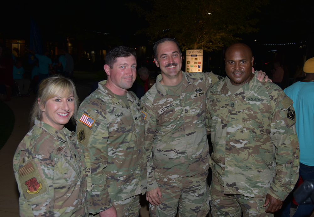 A group of soldiers are posing for a picture together.