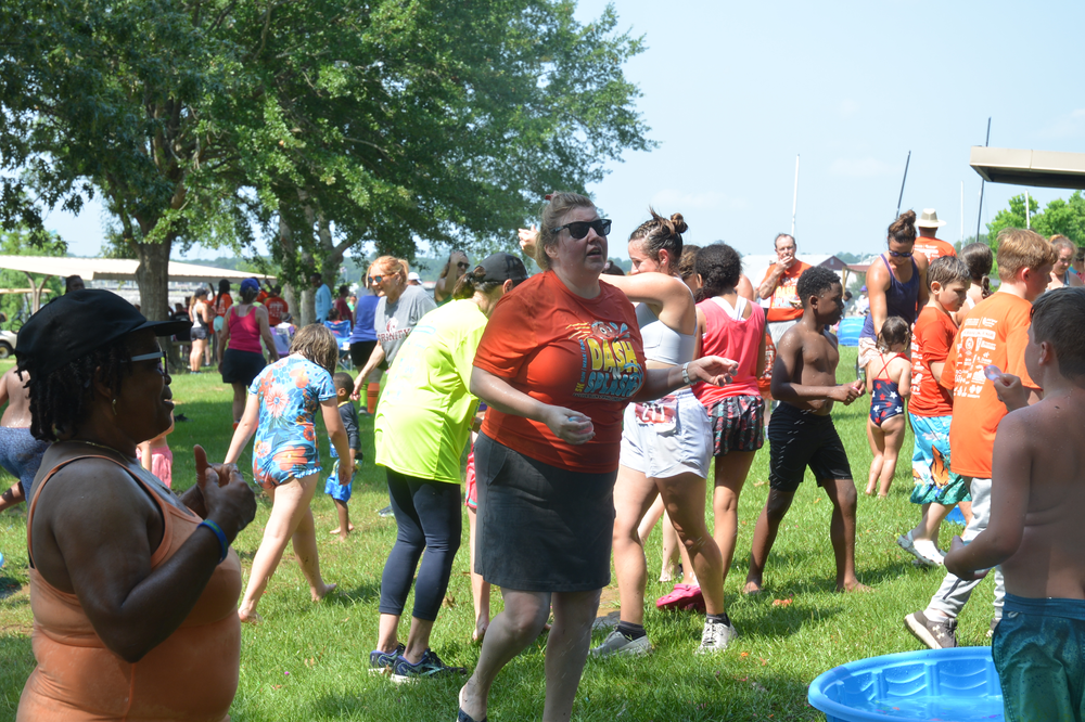 A group of people are dancing in a park.