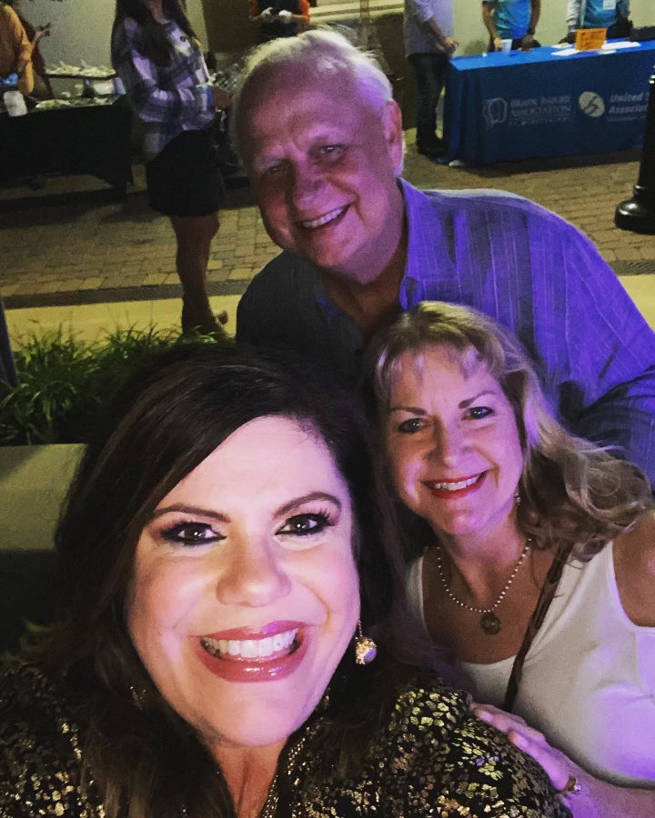 A man and two women are posing for a selfie