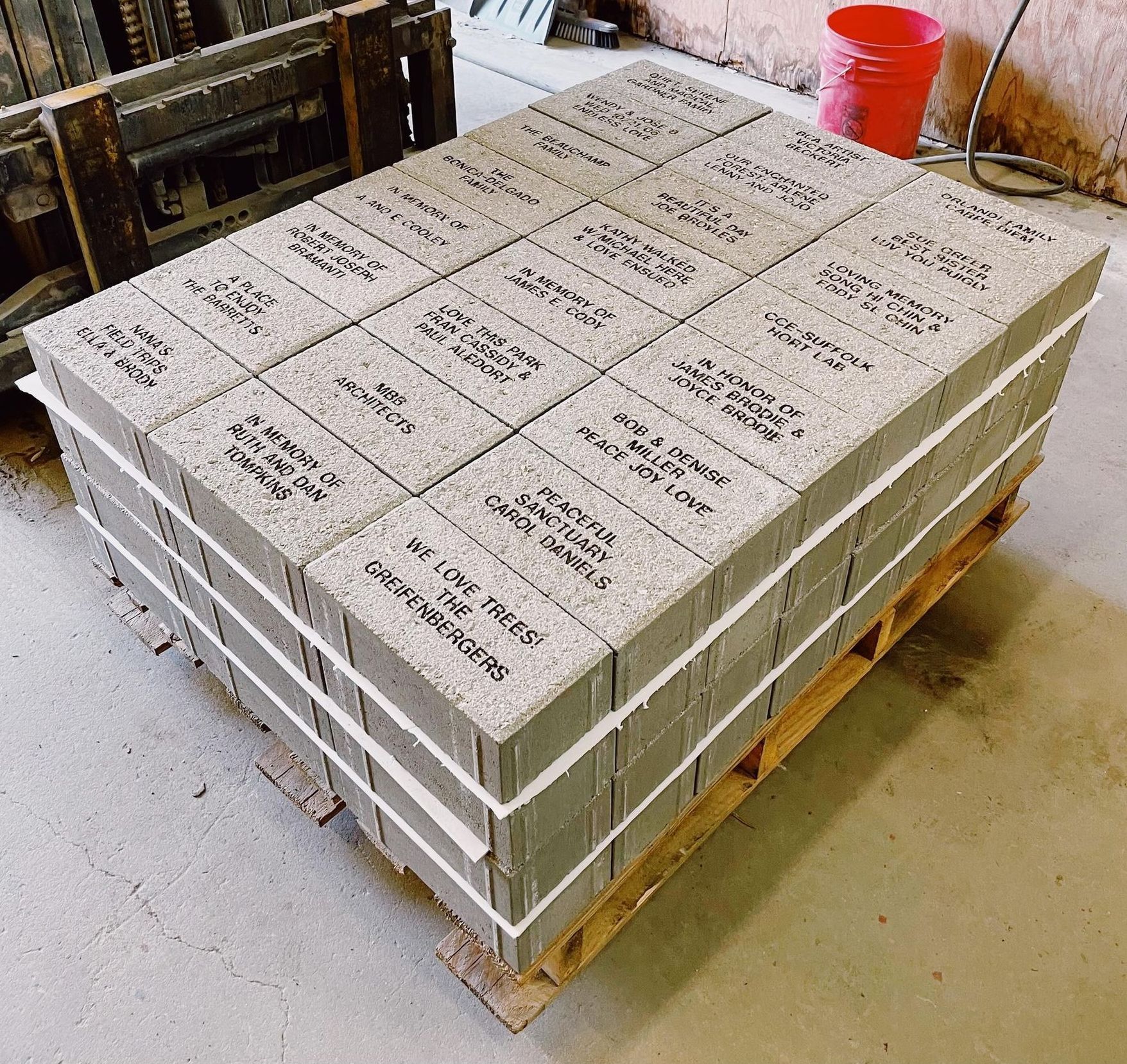 A pallet of bricks with a forklift in the background