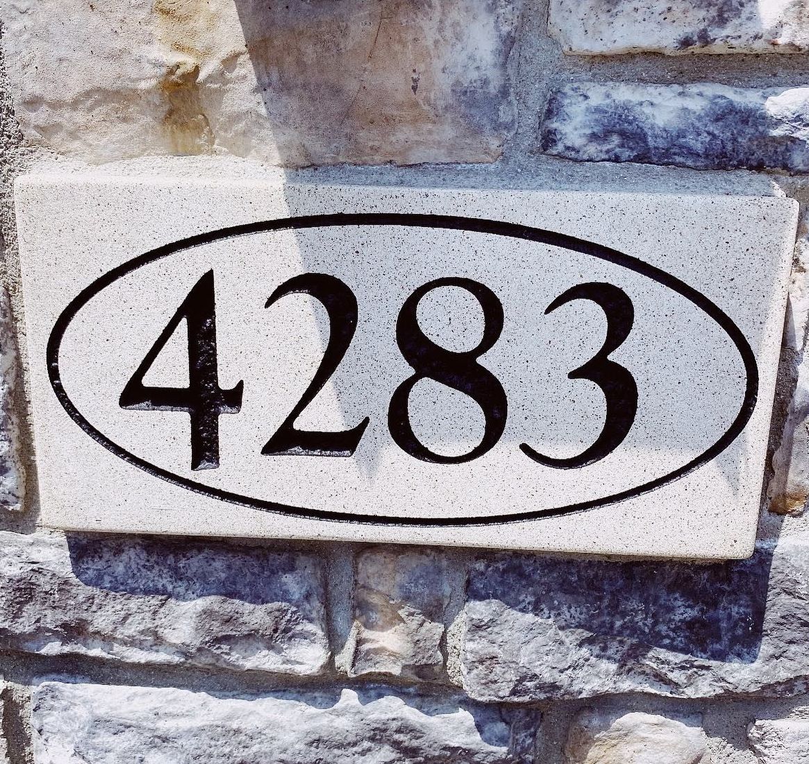 A stone sign with the number 4283 on it