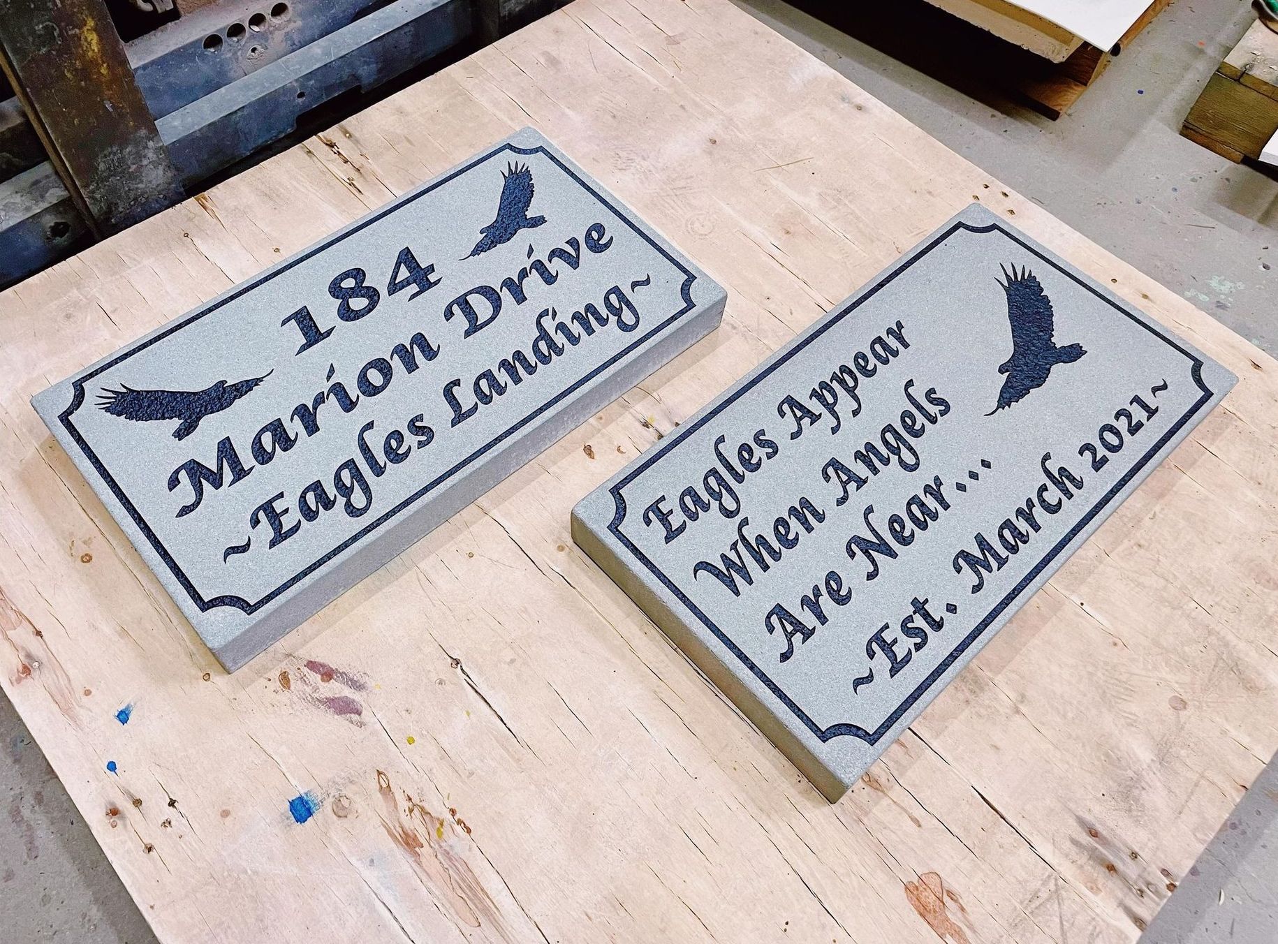 Two plaques with eagles on them are on a wooden table