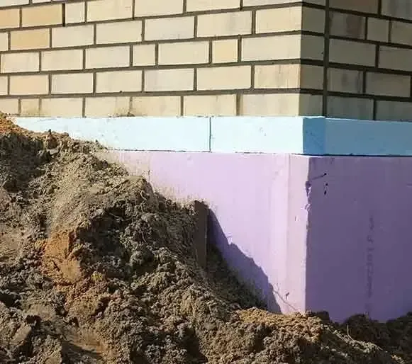 A pile of dirt is sitting next to a brick wall — Maximum Pest Management In Mareeba, QLD