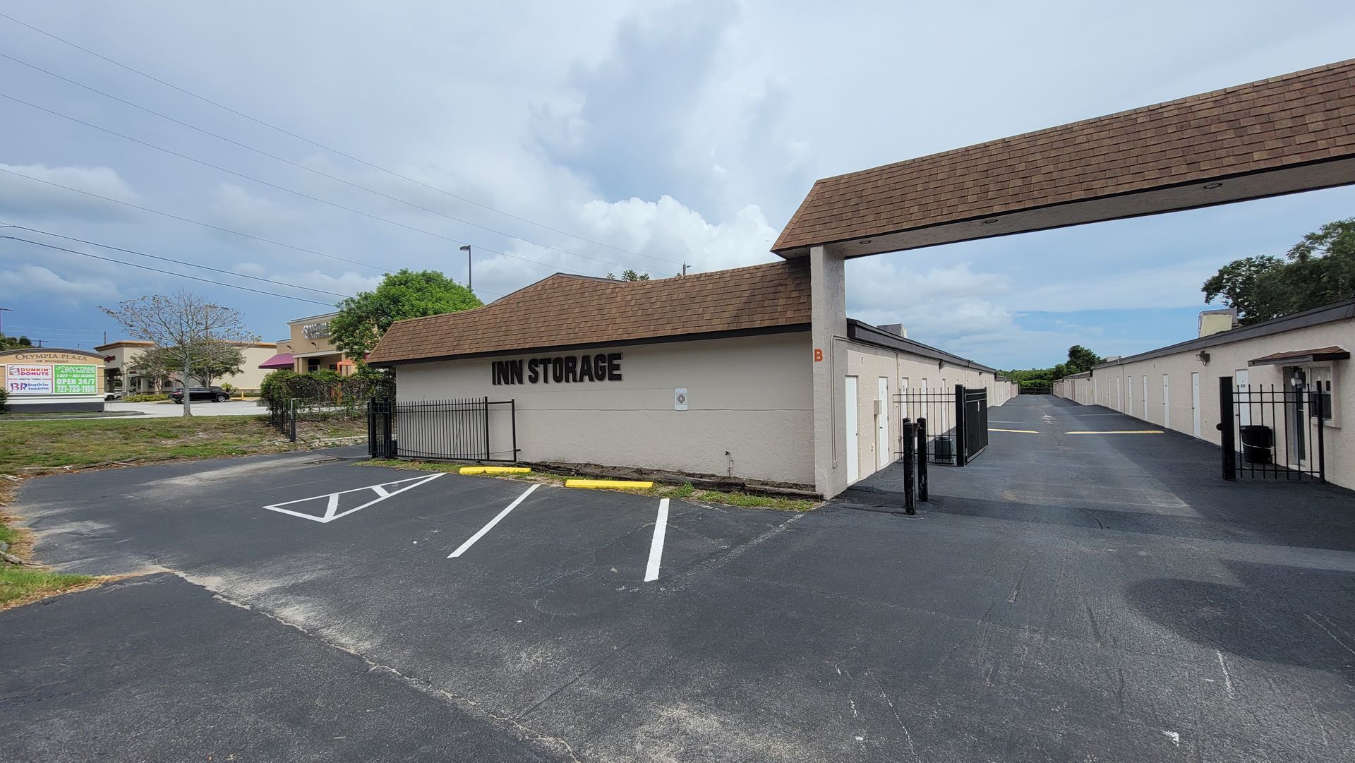 Wendy's restaurant exterior with drive-through lane, parking spaces, and cloudy sky