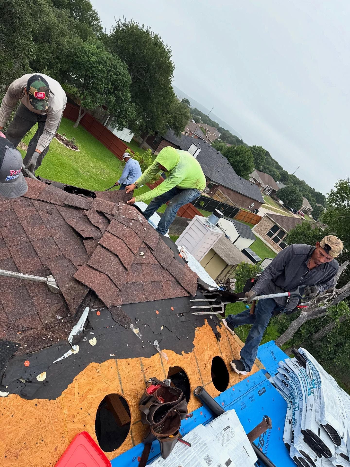 A group of men are working on a roof.