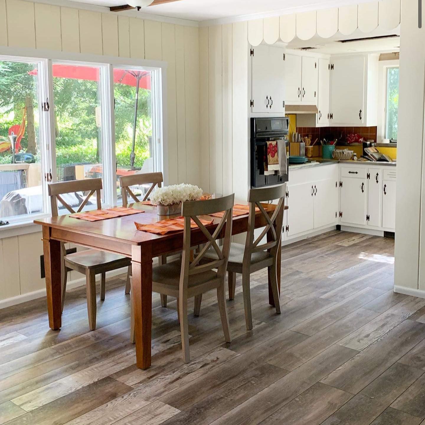 A kitchen with a table and chairs in it