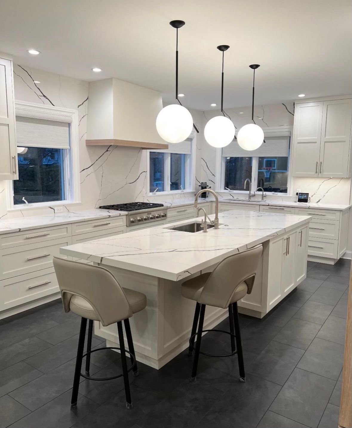A kitchen with a large island and stools