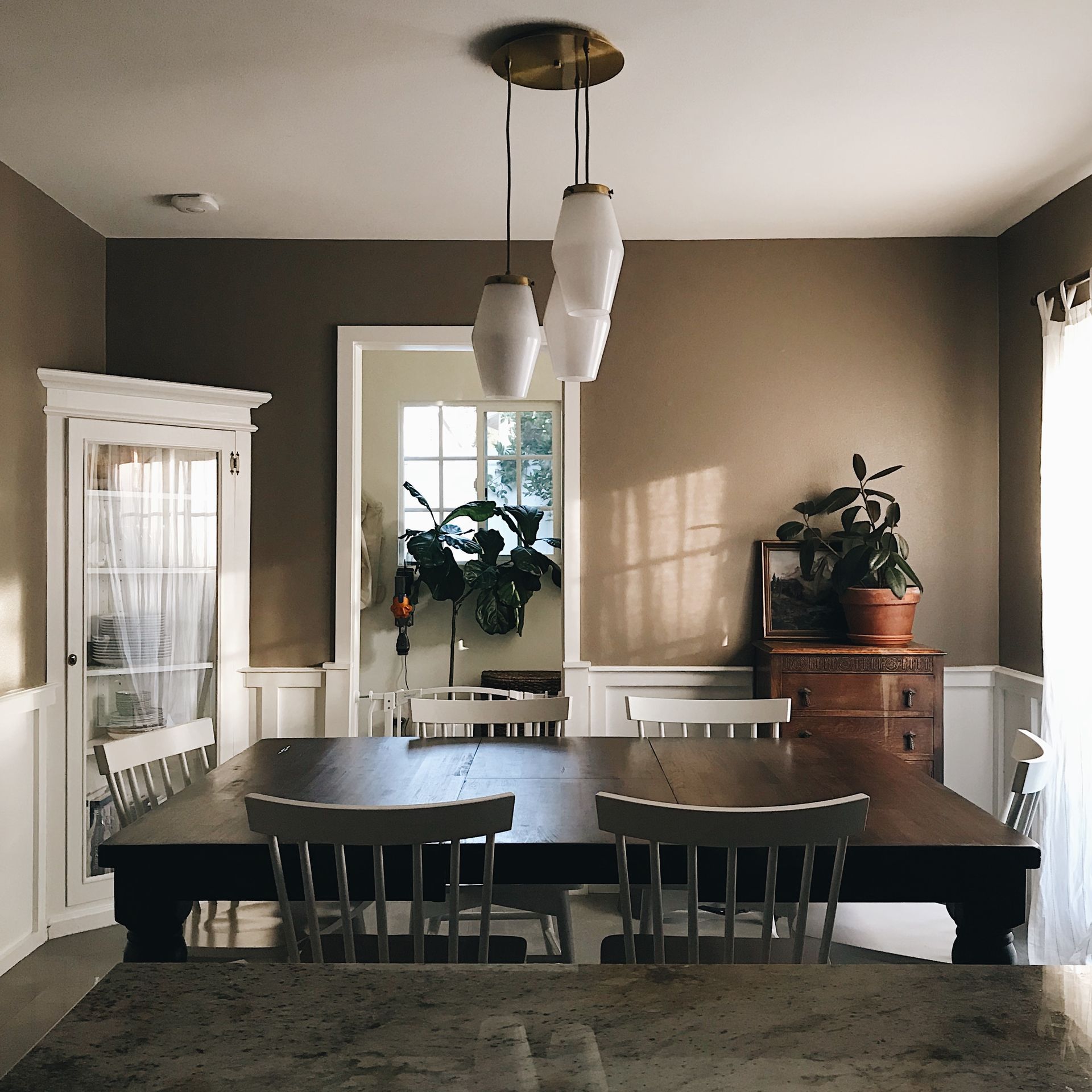 A dining room with a large table and chairs