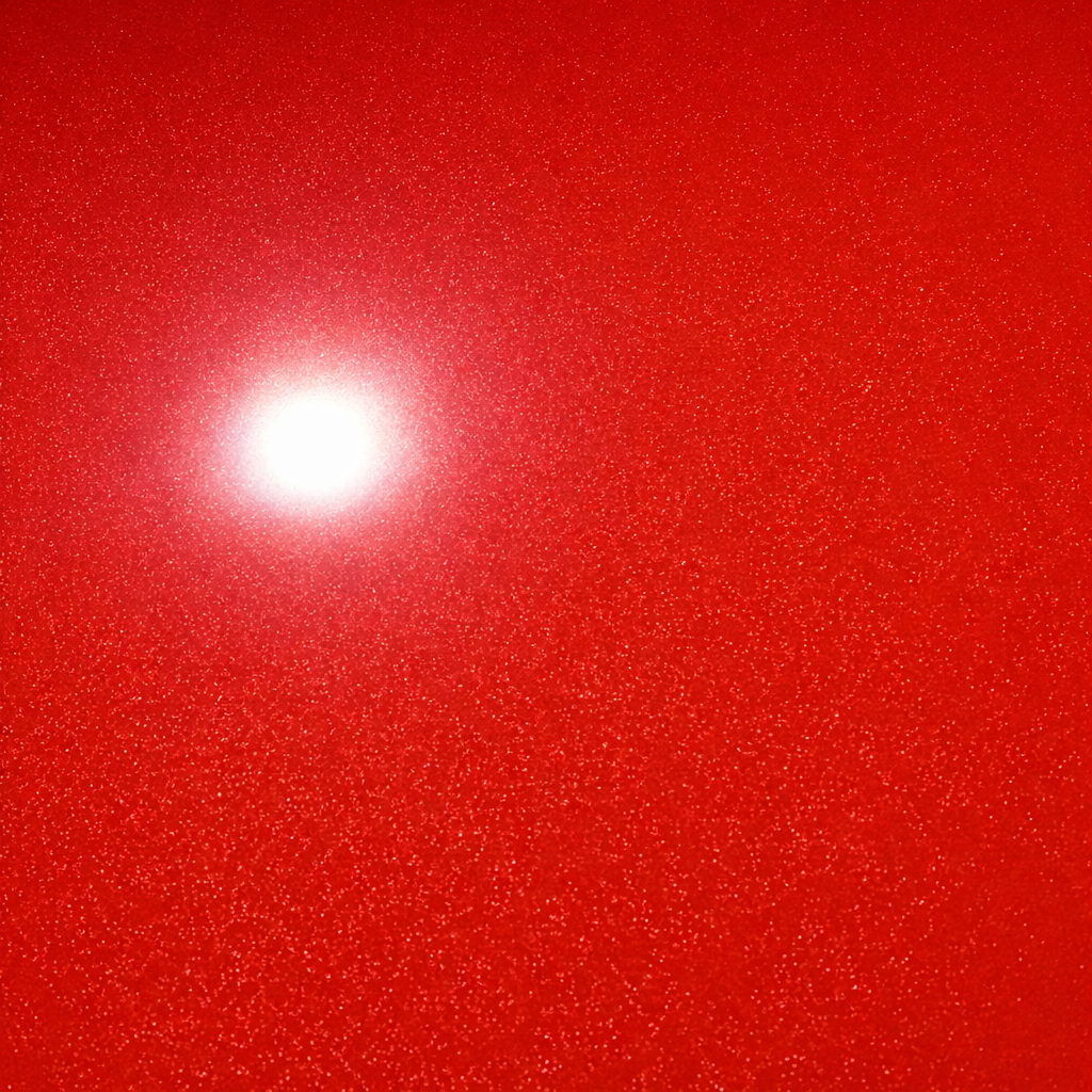 Red car door and window reflecting trees and sky.
