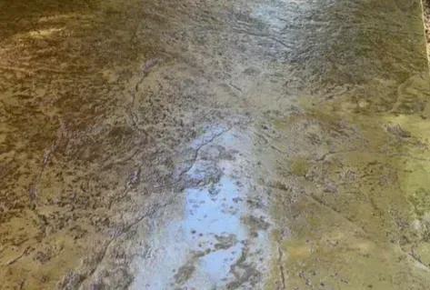Marbled stone or tile floor with a glossy finish and a bright reflection in the center