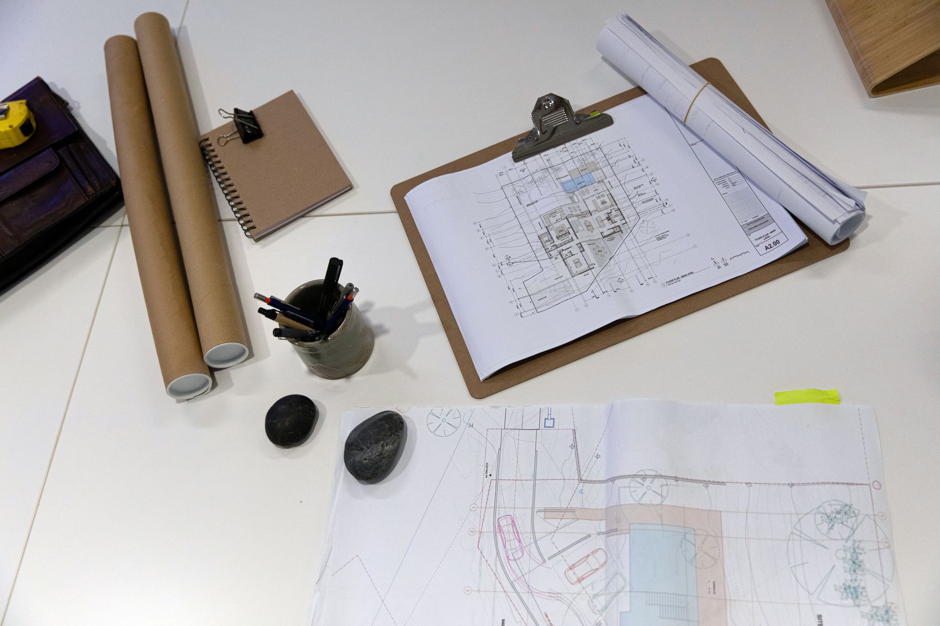 A clipboard with a drawing on it is sitting on a table.