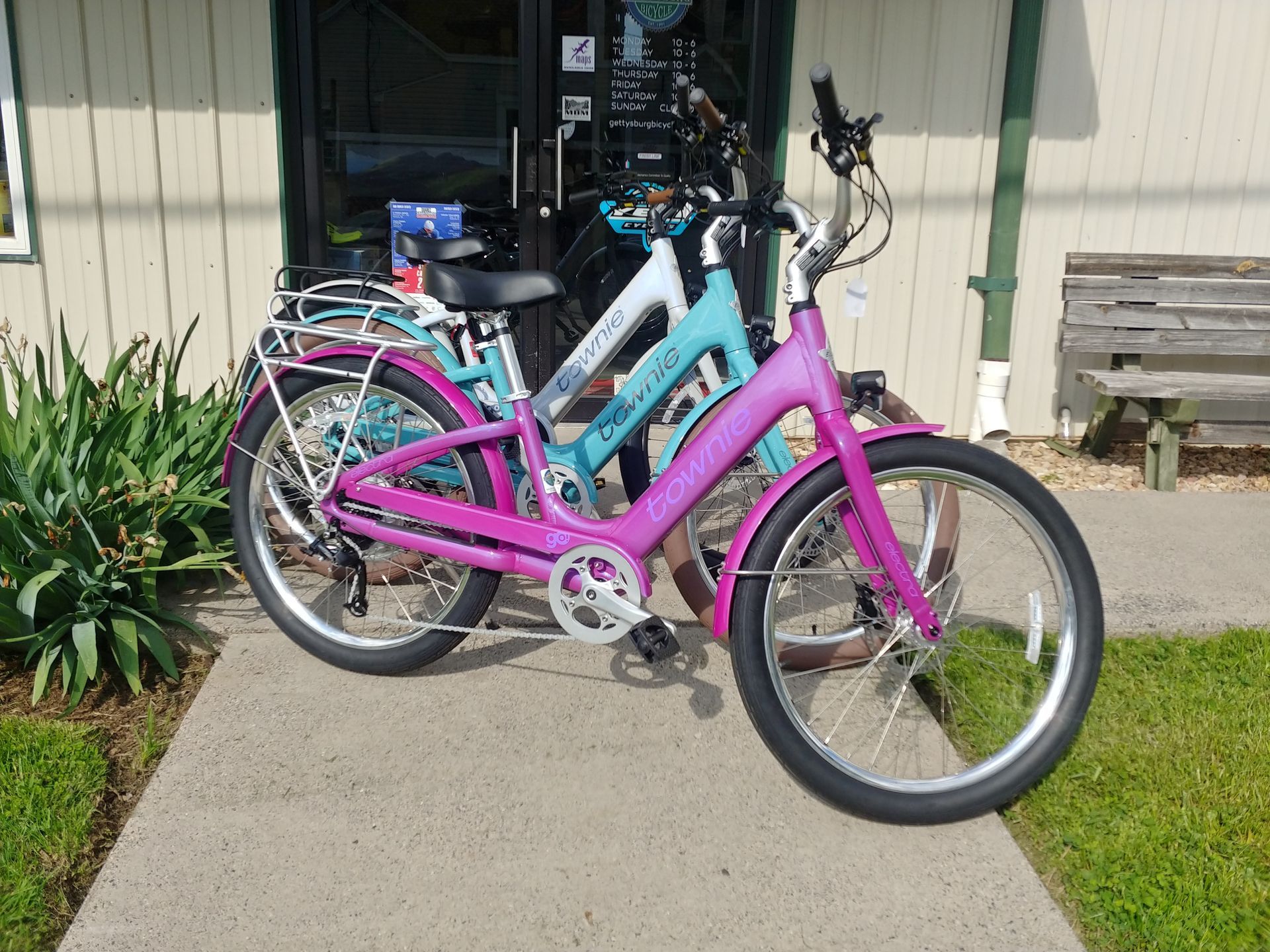 Two colorful bicycles parked on a driveway beside a house