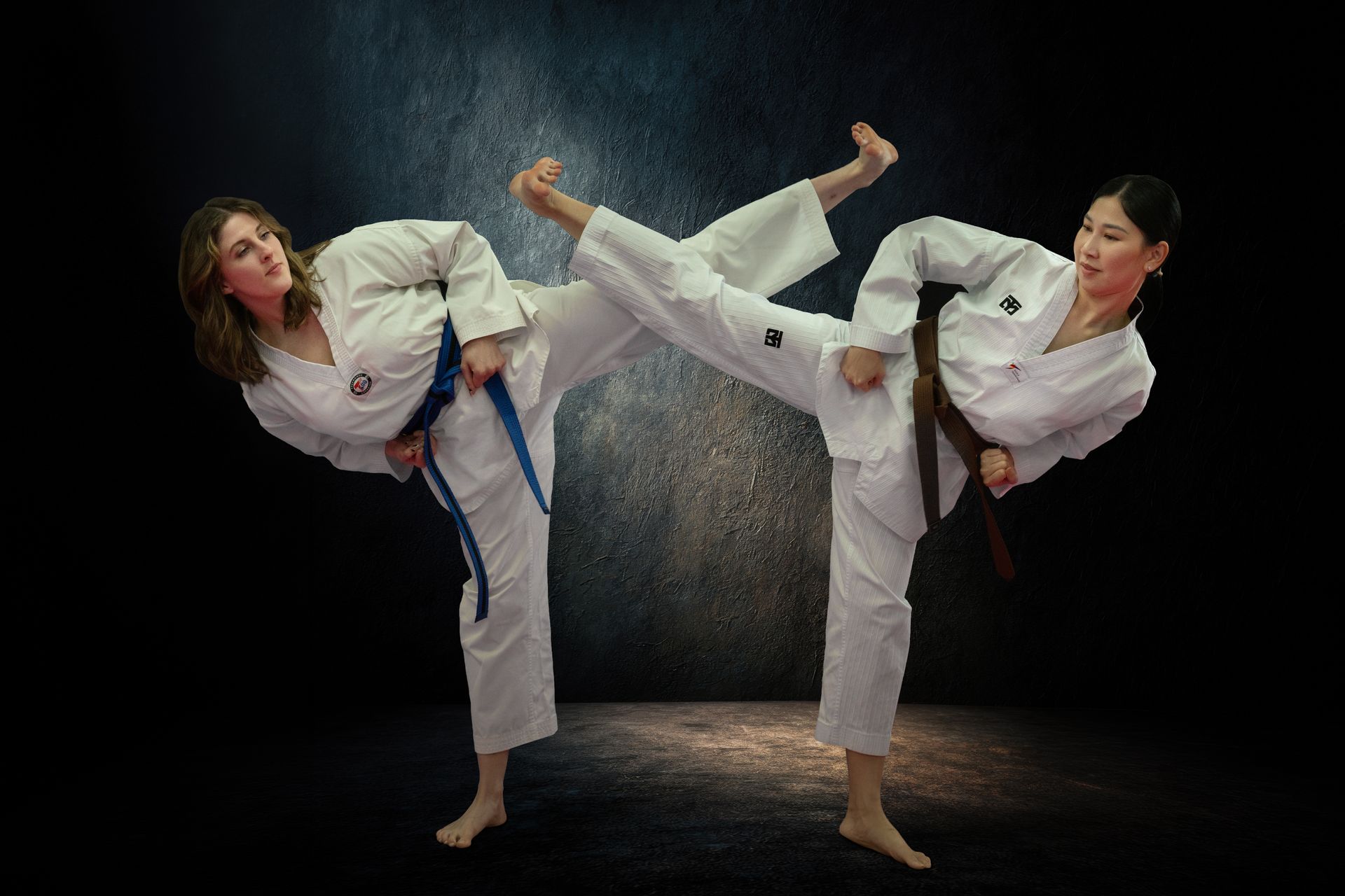 Students in martial arts uniforms stand in rows on pink and blue mats inside a dojo, facing forward during a class.