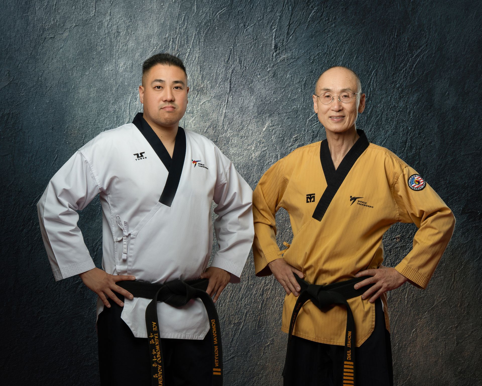 Taekwondo students wearing white uniforms and sparing.