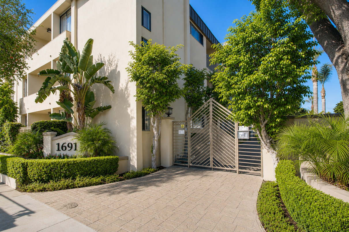 Sunlit apartment buildings with stairs, balconies, and desert landscaping at sunset