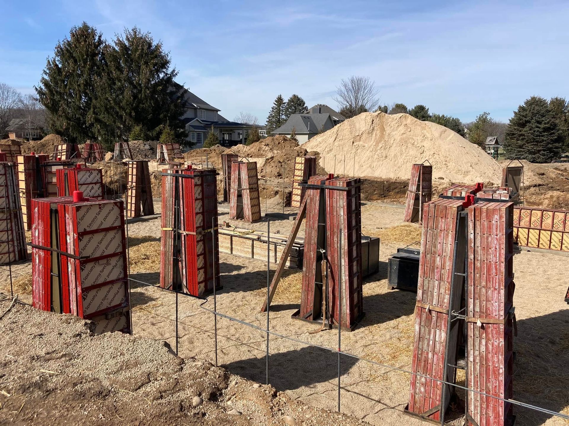 A construction site with a pile of dirt in the background.
