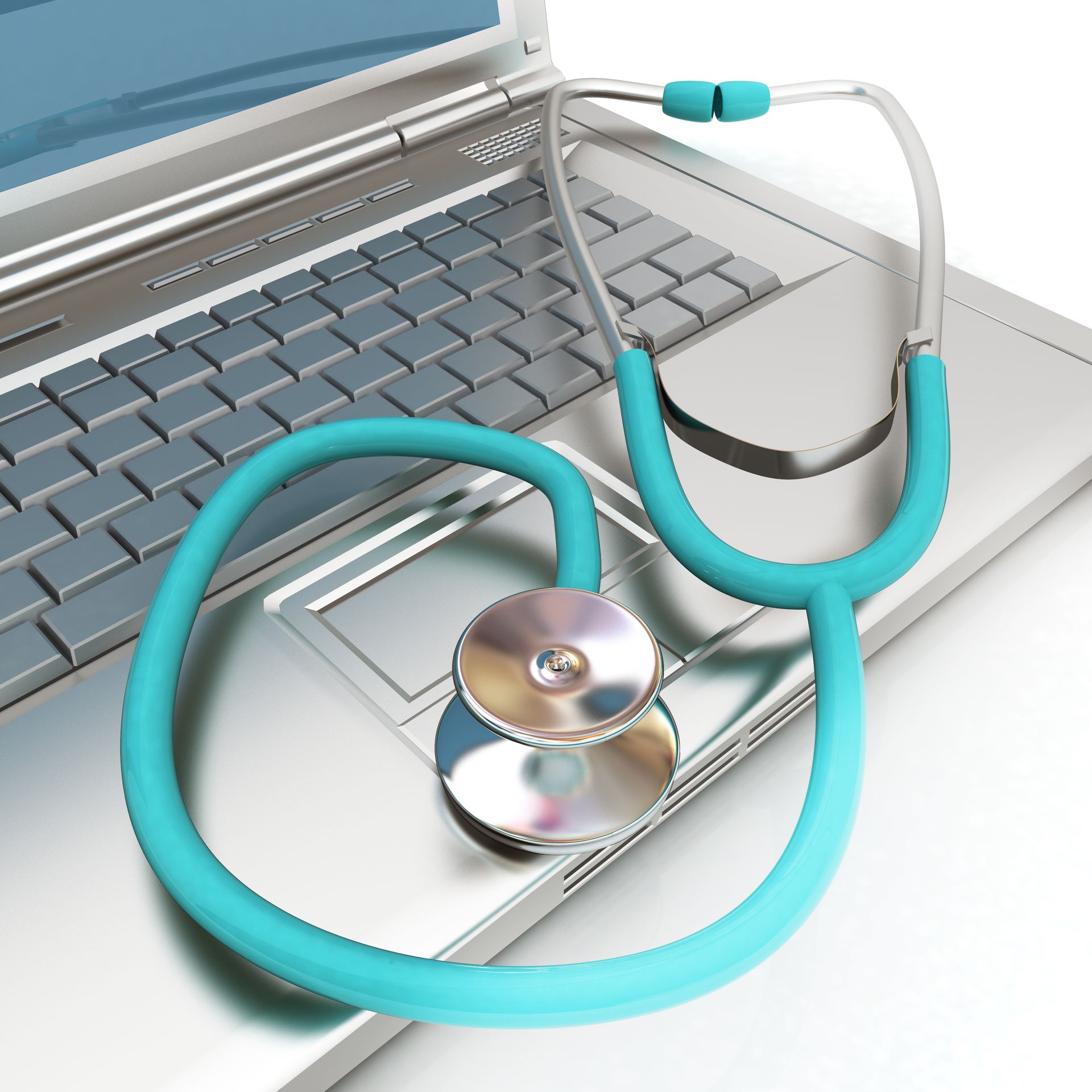 Turquoise stethoscope resting on a laptop keyboard and touchpad