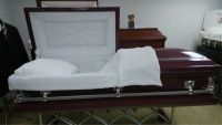 a casket is open and sitting on a table in a room .