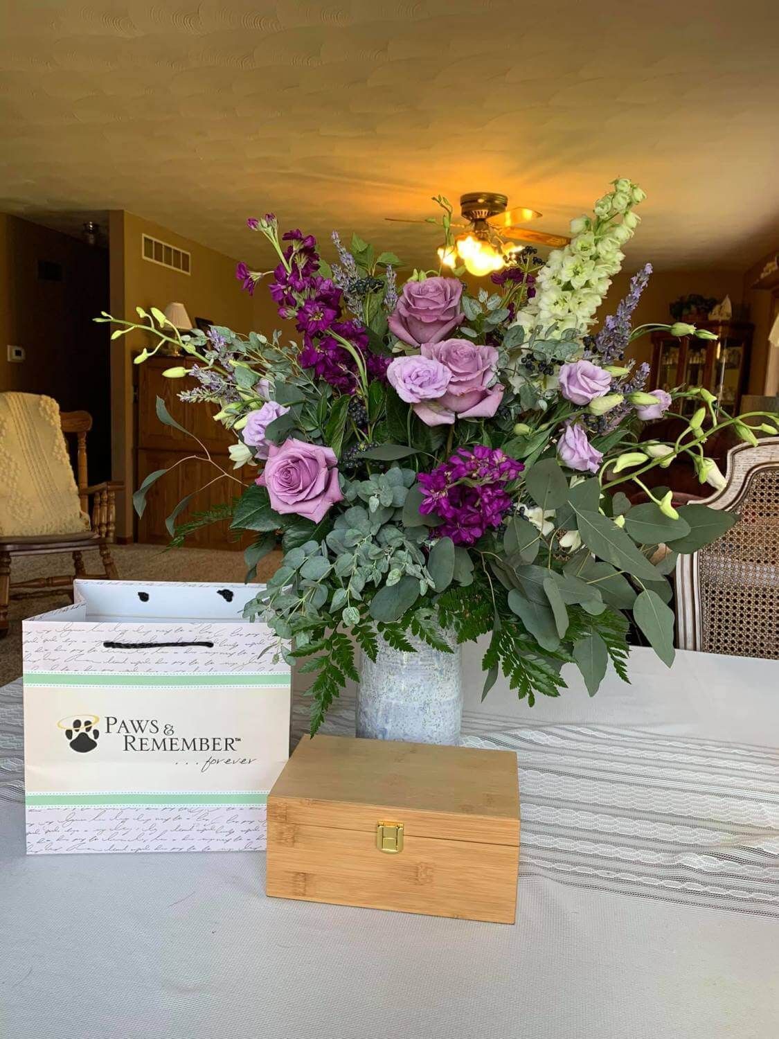 Gift bag an floral arrangement and urn.
