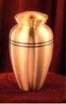a gold urn is sitting on top of a red table .