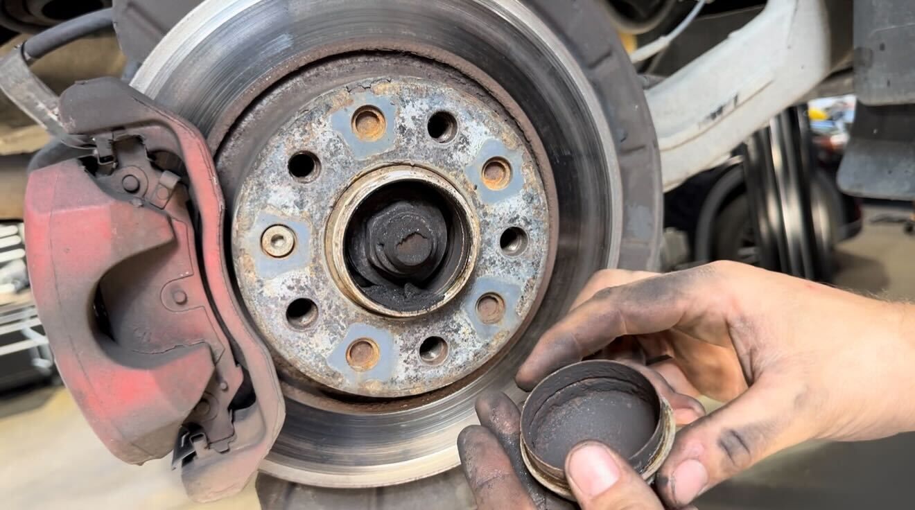 Close-up of worn brake pad and rotor during brake repair inspection at Wayside Garage in Seaside CA