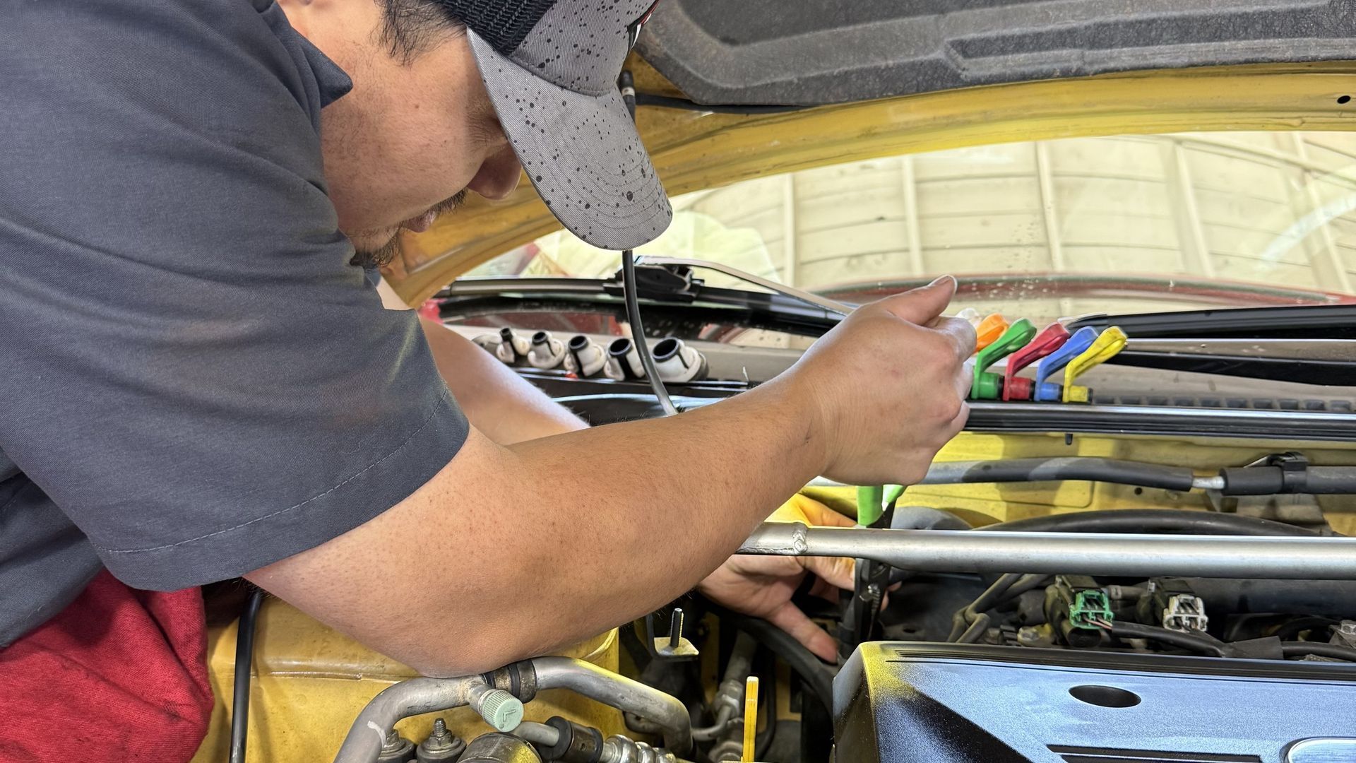 Auto technician performing fuel system diagnostic at Wayside Garage in Seaside California