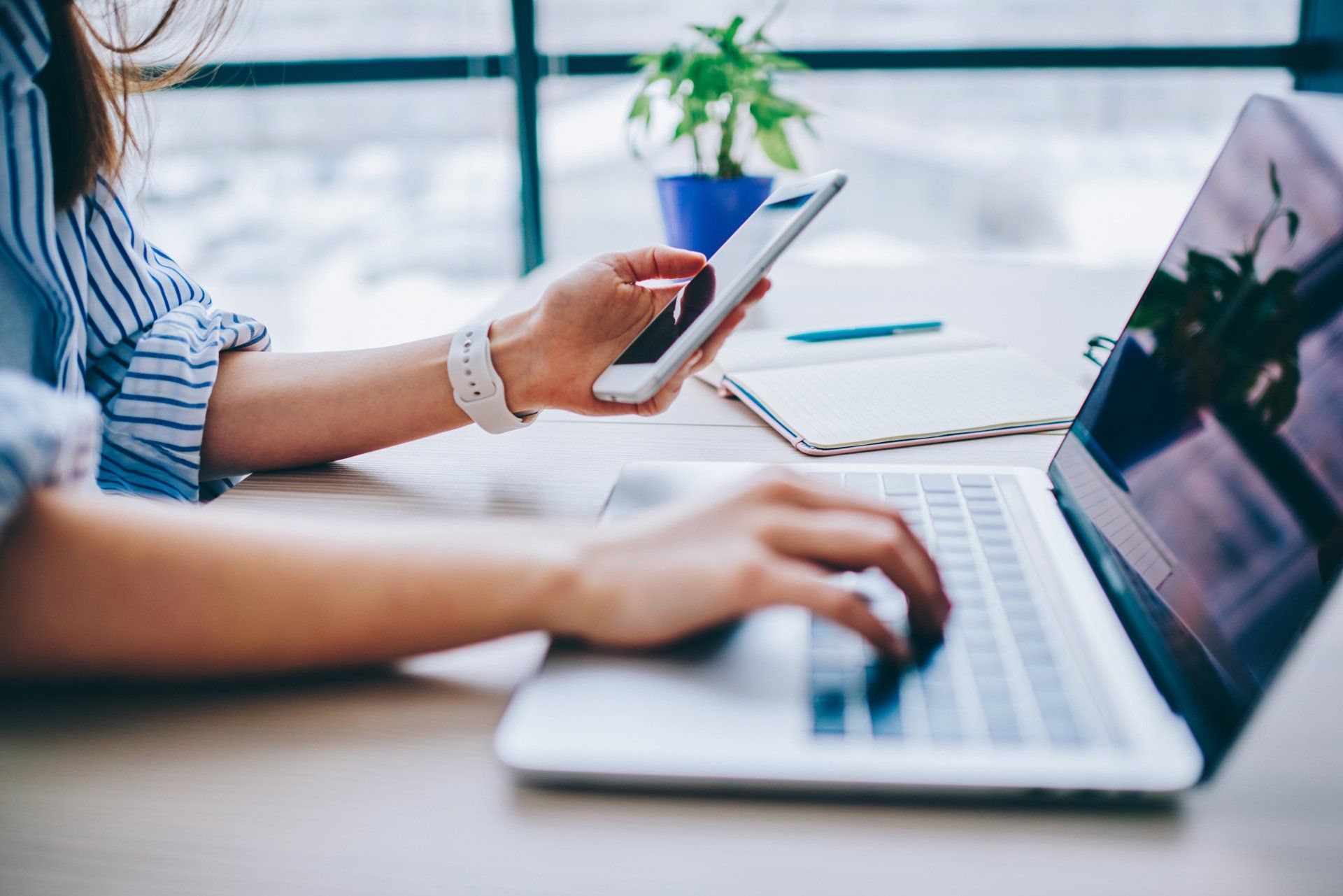 woman using laptop and phone for content