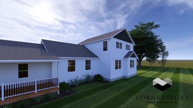 White farmhouse with porch and garage on a grassy lot under a blue sky at sunset