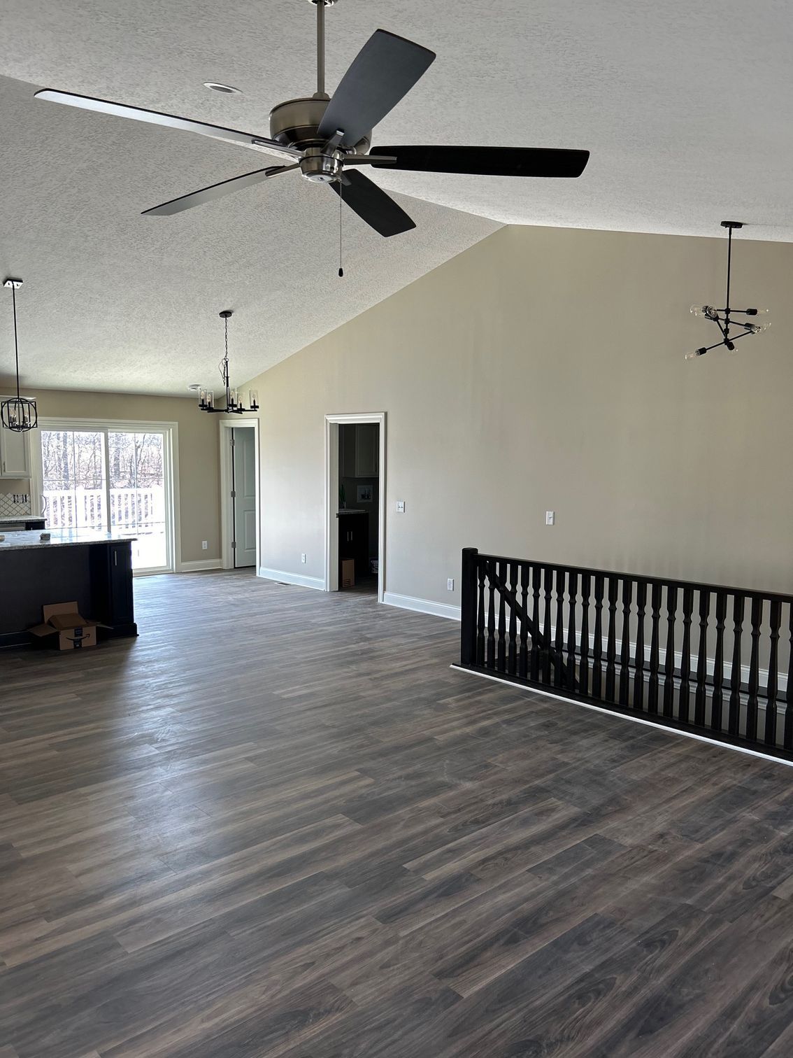 There is a ceiling fan in the middle of the room.